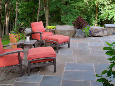 Patio with 2 Adirondack chairs with orange cushions