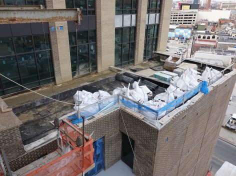 Balcony areas filled with bags of soil, rock and materials for green roof