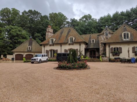 European Villa style with pea gravel driveway